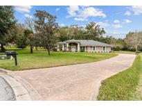 Single-story home with landscaped yard and circular driveway at 7237 Edmund Ct, Mount Dora, FL 32757