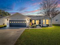 Attractive single-story home with a two-car garage and well-manicured lawn at 830 Cortez Ave, The Villages, FL 32159