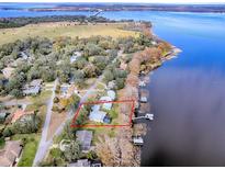 Aerial view showing home's location on lakefront property with surrounding houses at 908 N Lakeshore Blvd, Howey In The Hills, FL 34737