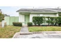 Well-maintained townhouse with green exterior, landscaping, and walkway at 1015 Stucki Ter, Winter Garden, FL 34787