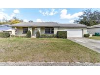 Charming single-story home with a well-maintained lawn and attached two-car garage at 118 Shomate Dr, Longwood, FL 32750