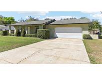 Charming single story home with a two car garage, well maintained lawn, and mature landscaping at 118 Shomate Dr, Longwood, FL 32750