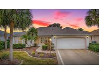 Inviting one-story home with landscaped yard and two-car garage at 1218 Augustine Dr, Lady Lake, FL 32159