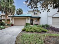 Inviting exterior featuring a two-car garage and landscaped front yard at 1235 Avenida De Las Casas, The Villages, FL 32159