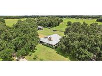 Aerial view of a house on a large lot with a barn and lush greenery at 1392 Sw 103Rd Ave, Webster, FL 33597