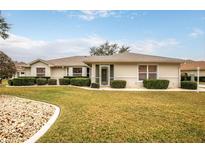 Single-story house with well-maintained lawn at 21721 Loch Haven Pass, Leesburg, FL 34748