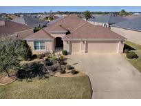 Single-Gathering home with a two-car garage and well-manicured lawn at 3144 Blackstock Way, The Villages, FL 32163