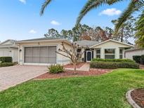 Single-story home with screened porch and landscaped yard at 353 Ranchwood Dr, Leesburg, FL 34748