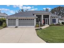 Attractive one-story home with a three-car garage and well-manicured lawn at 4928 Kelso St, Leesburg, FL 34748