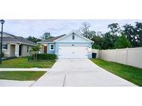 Charming blue home featuring a spacious driveway and a manicured front yard at 2295 Delhi Pl, Sanford, FL 32771