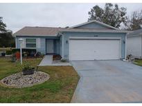 Cute Florida home with attached garage and landscaped yard at 32218 Sweet Briar Court, Leesburg, FL 34748