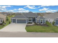 Beautiful single-Gathering home featuring a manicured lawn and three-car garage at 4442 Shannon Loop, The Villages, FL 32163
