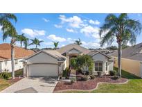 Beautiful one-story home with a landscaped yard and two-car garage at 2134 Zaragoza Pl, The Villages, FL 32159