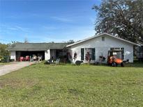 Ranch-style home with attached garage and large yard at 225 N West St, Bushnell, FL 33513