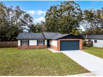 Updated single story home with a new garage door and landscaping at 2725 Lakewood Ln, Eustis, FL 32726