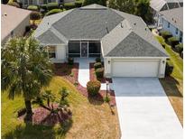 Single-story home with gray roof, attached garage, and landscaped yard at 3488 Sterling St, The Villages, FL 32162