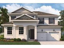 Inviting two-story home featuring a two-car garage, manicured lawn, and classic architectural details at 5155 Firebush Dr, Apopka, FL 32712