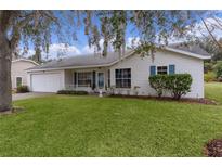 Charming single story home with a spacious lawn and attached garage at 5530 Tangelo St, Leesburg, FL 34748