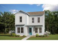 Charming two-story home featuring bright white siding and a welcoming turquoise front door, nestled in a landscaped yard at 9918 Fiddley Aly, Orlando, FL 32827
