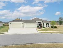 Beautiful 3-car garage home with landscaped yard at 11189 Roz Way, Oxford, FL 34484