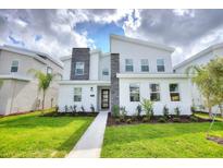 Modern two-story home with stone accents and landscaped lawn at 1257 Challenge Dr, Davenport, FL 33896