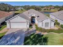 Beautiful home with landscaped yard, paver driveway, and two-car garage at 16841 Se 84Th Colerain Cir, The Villages, FL 32162