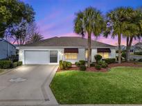 Charming single-story home with a two-car garage and lush landscaping at 2001 Cordero Ct, The Villages, FL 32159