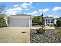 Attractive single-story home with a two-car garage and landscaped front yard at 3257 Kilarny Pl, The Villages, FL 32163