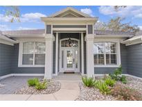 Gray house exterior with white columns and landscaping at 5055 County Road 125 # B1, Wildwood, FL 34785