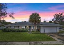 White single-story house with a palm tree and attached garage at 5938 Marlberry Dr, Orlando, FL 32819