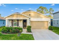 Charming single-story home with a two-car garage, well-maintained landscaping, and a welcoming front porch at 10161 Spring Lake Dr, Clermont, FL 34711