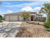 Charming single-story home with well-maintained landscaping and a three-car garage at 12886 Se 97Th Terrace Rd, Summerfield, FL 34491