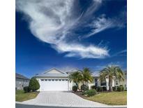 Charming single-story home boasts a brick driveway, well-manicured landscaping, and a two-car garage at 1541 Fenimore Ln, The Villages, FL 32162