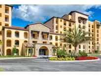 Luxury condo building with stone accents and resort-style landscaping at 16300 County Road 455 # 414, Bella Collina, FL 34756