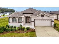 One-story home with a two-car garage and well-manicured lawn at 16904 Se 110Th Court Rd, Summerfield, FL 34491