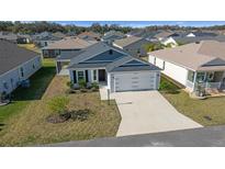 Well-manicured lawn and neutral tones highlight this charming single-story home with a two car garage at 4654 Ramsell Rd, The Villages, FL 32163