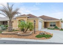 Single-story home with attractive landscaping and a two-car garage at 583 Arruda Ter, The Villages, FL 32162