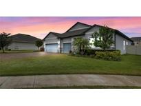 Beautiful home with two-car garage and landscaped lawn at 729 Calabria Way, Howey In The Hills, FL 34737