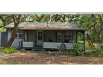 Quaint cottage-style home with a covered front porch, offering a relaxing outdoor space at 10094 Sw 153Rd Ln, Dunnellon, FL 34432