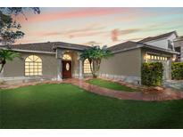 One-story home with a landscaped lawn and a paved walkway leading to the entrance at 520 Brimming Lake Rd, Minneola, FL 34715