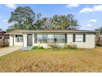 One-story house with a large front yard and driveway at 1412 N Garfield Ave, Deland, FL 32724