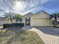 Well-maintained single-story home with a two-car garage and landscaped yard at 3916 Doune Way, Clermont, FL 34711