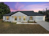 Charming single-story house with gray roof and white exterior at 51 Aspen Rd, Ocala, FL 34480