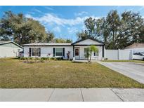 Charming ranch home with white exterior, landscaping, and driveway at 1301 Sand Pine Ave, Ocoee, FL 34761