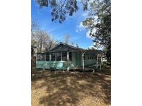 Charming light blue house with a porch and large yard at 13369 Cr 719, Webster, FL 33597