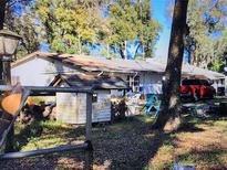 Ranch-style home with a large yard and mature trees at 148 Cr 532W, Bushnell, FL 33513