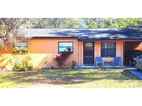 Charming single-story home with a well-maintained lawn and covered porch at 15906 Douglas Rd, Mascotte, FL 34753