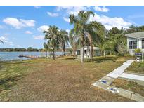 Charming lakefront home with dock and lush landscaping at 39645 Turek Ln, Umatilla, FL 32784