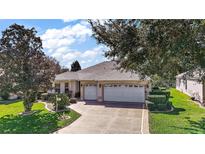 Attractive single-story home with a two-car garage and well-manicured lawn at 526 Kingston Way, The Villages, FL 32162