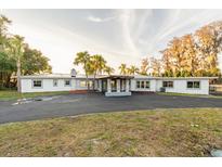 Stunning curb appeal of a renovated home with a long driveway at 5526 Parkdale Dr, Orlando, FL 32839